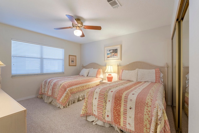 carpeted bedroom featuring a closet and ceiling fan