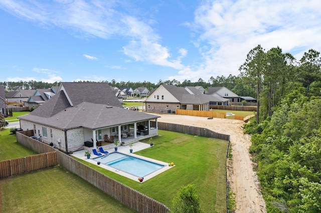 exterior space with a patio and a lawn