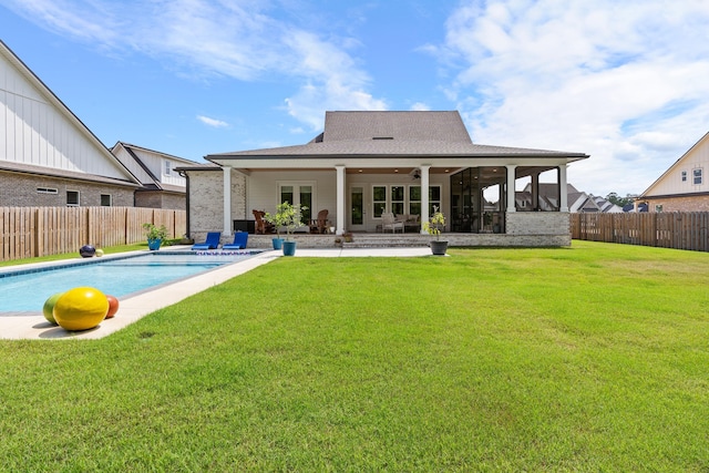 back of property featuring a fenced in pool, a patio, ceiling fan, and a yard