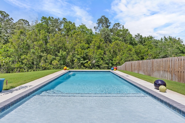 view of pool with a yard