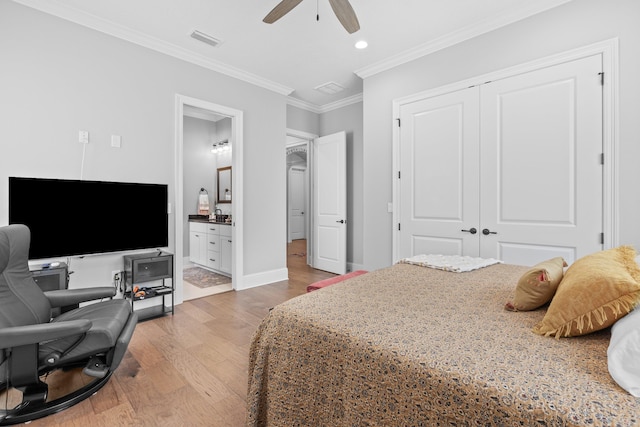 bedroom with a closet, ceiling fan, connected bathroom, hardwood / wood-style floors, and ornamental molding