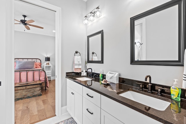 bathroom featuring ceiling fan, hardwood / wood-style floors, and dual vanity