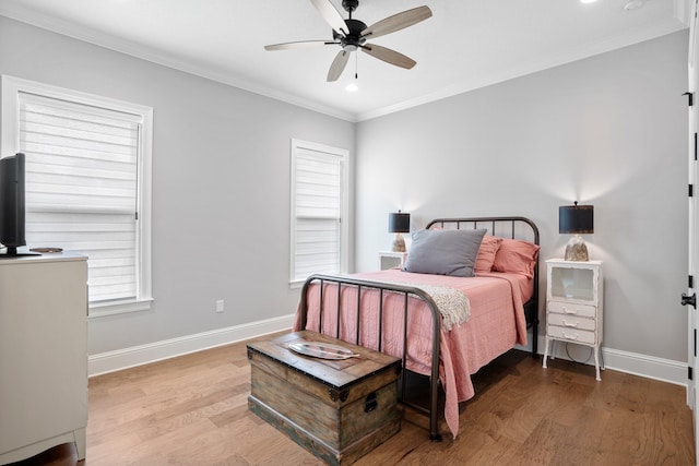 bedroom featuring hardwood / wood-style floors, ceiling fan, and ornamental molding