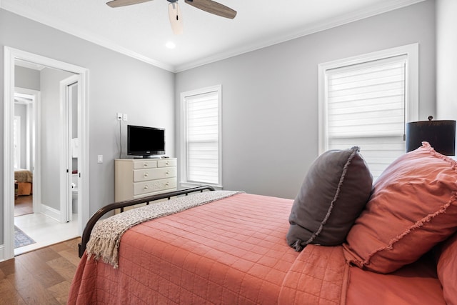 bedroom featuring ornamental molding, wood-type flooring, and ceiling fan