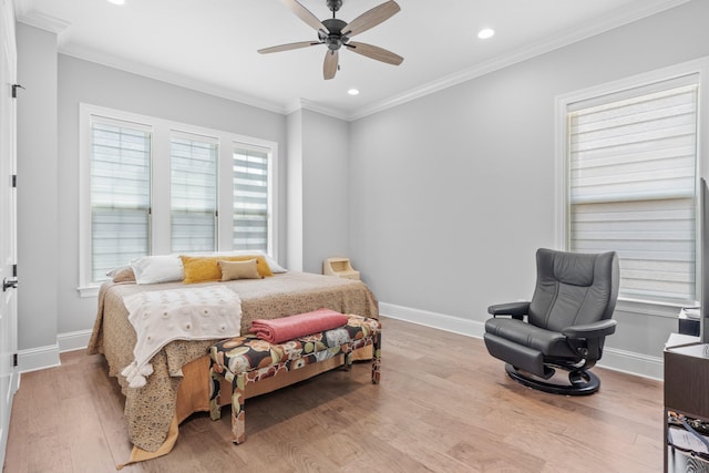 bedroom featuring light hardwood / wood-style flooring, ceiling fan, and ornamental molding