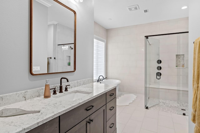 bathroom featuring tile flooring, double sink vanity, and a shower with shower door