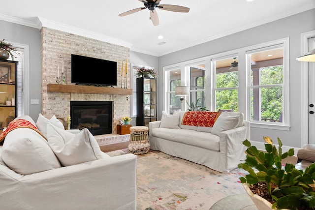 living room with ornamental molding, ceiling fan, and a brick fireplace