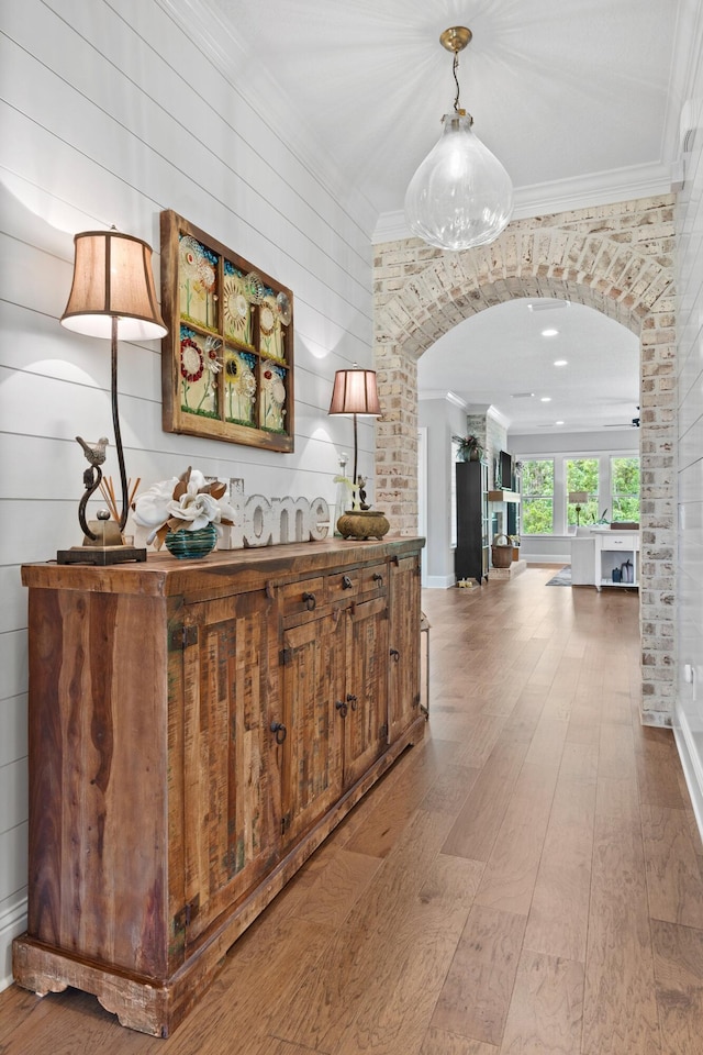 hall with crown molding and hardwood / wood-style floors