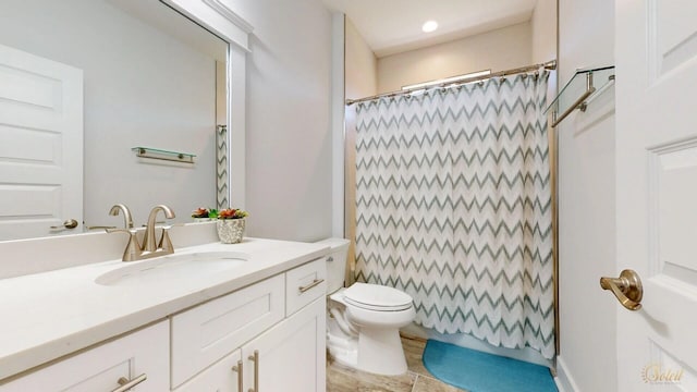 bathroom with tile floors, toilet, and large vanity