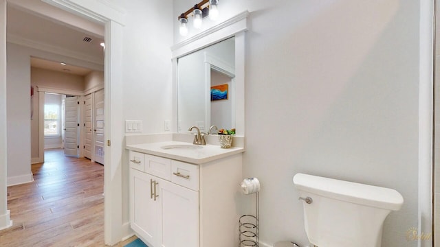 bathroom featuring vanity, toilet, and hardwood / wood-style flooring