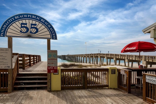 wooden terrace featuring a water view