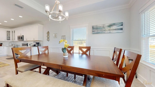 dining space with an inviting chandelier and ornamental molding