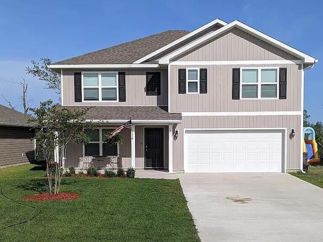 view of front of home featuring a front lawn and a garage