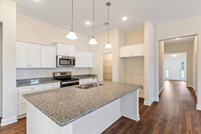 kitchen with sink, white cabinets, an island with sink, and appliances with stainless steel finishes