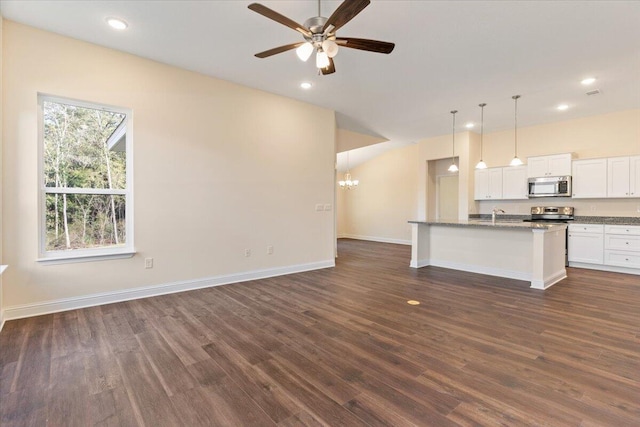 unfurnished living room featuring sink, ceiling fan with notable chandelier, and dark hardwood / wood-style floors