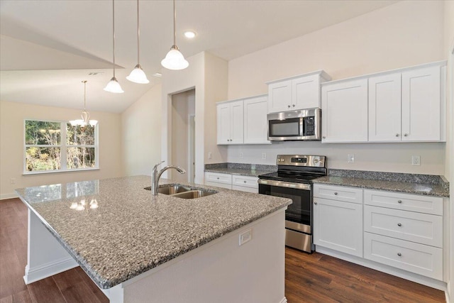 kitchen with stainless steel appliances, vaulted ceiling, sink, a center island with sink, and white cabinets