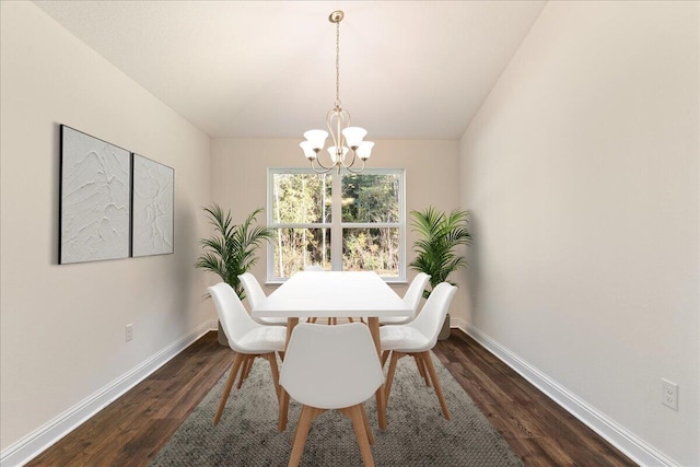 dining space featuring dark hardwood / wood-style flooring and a notable chandelier