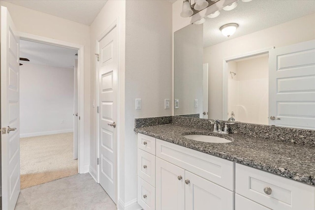 bathroom with vanity and a textured ceiling