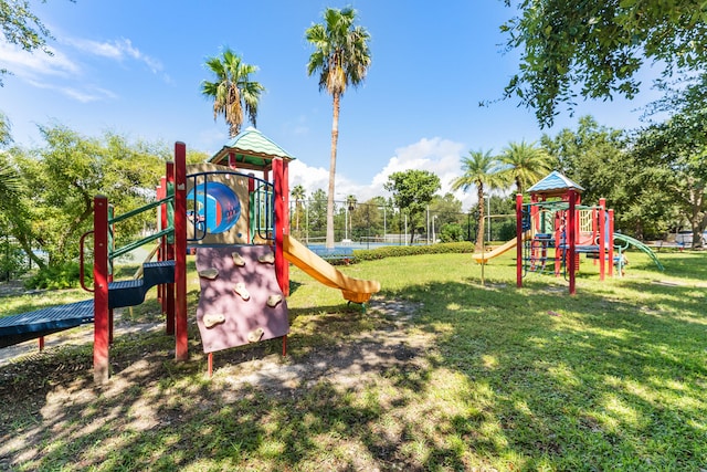 community playground featuring a lawn and fence