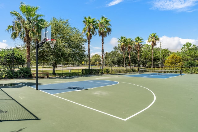 view of sport court with a tennis court, community basketball court, and fence