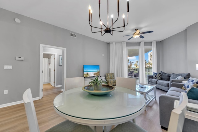 dining space with light wood-style floors, visible vents, baseboards, and a ceiling fan