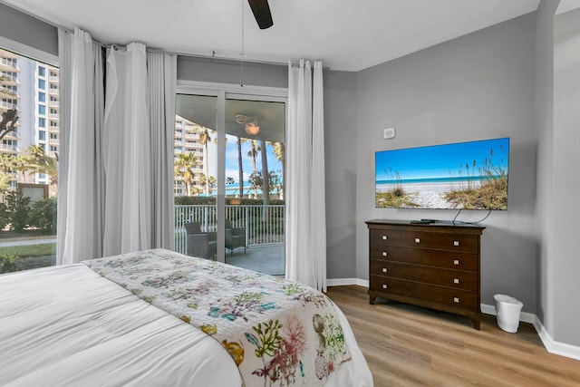 bedroom with baseboards, ceiling fan, light wood finished floors, and access to exterior