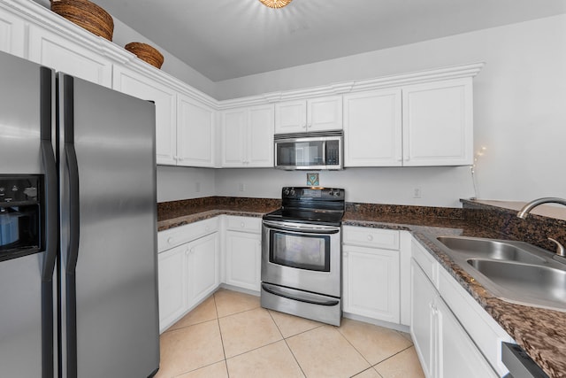 kitchen with sink, stainless steel appliances, white cabinets, and light tile floors