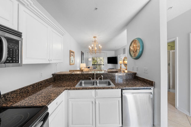 kitchen with stainless steel appliances, a chandelier, white cabinets, sink, and light tile floors