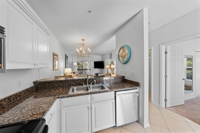 kitchen with sink, plenty of natural light, light tile flooring, and dishwasher