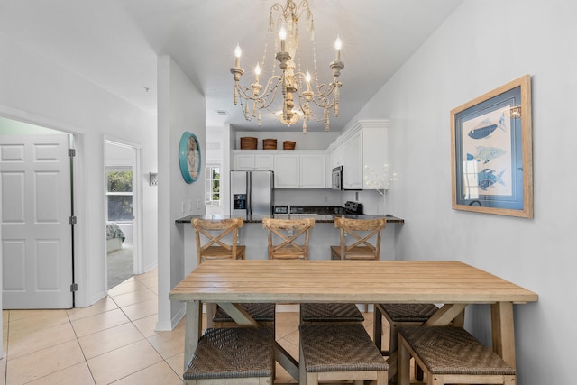 dining area with an inviting chandelier and light tile flooring