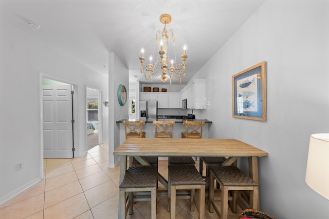 tiled dining area with a chandelier