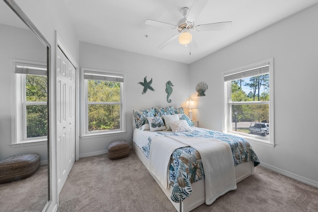 carpeted bedroom featuring a closet and ceiling fan