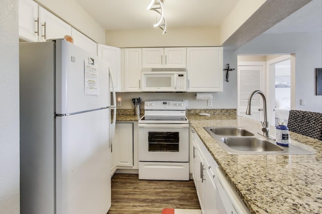 kitchen with dark wood finished floors, white appliances, white cabinetry, and a sink