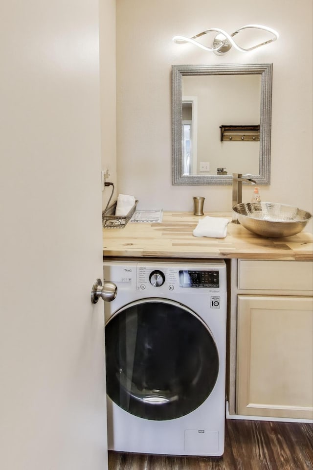 laundry area with washer / dryer, dark wood-type flooring, and a sink