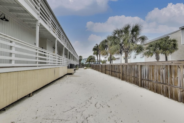 exterior space with central AC and fence