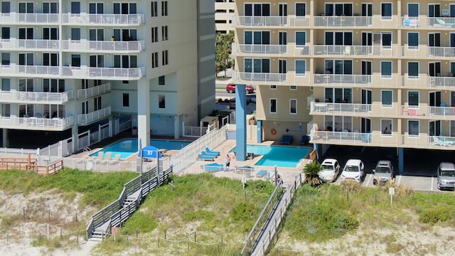 view of building exterior featuring a community pool