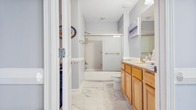 full bathroom with enclosed tub / shower combo, tile floors, vanity, and toilet