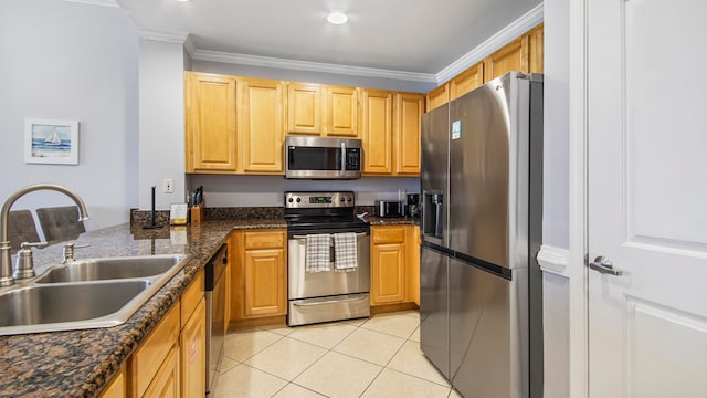 kitchen with crown molding, stainless steel appliances, light tile floors, and sink