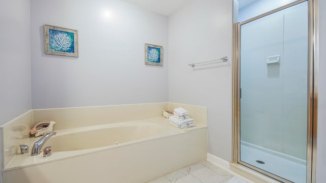 bathroom featuring independent shower and bath and tile floors