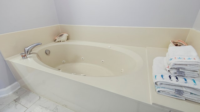 bathroom featuring tile floors and a bath