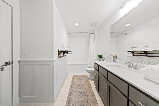 full bathroom with hardwood / wood-style floors, vanity, shower / bathtub combination with curtain, and toilet