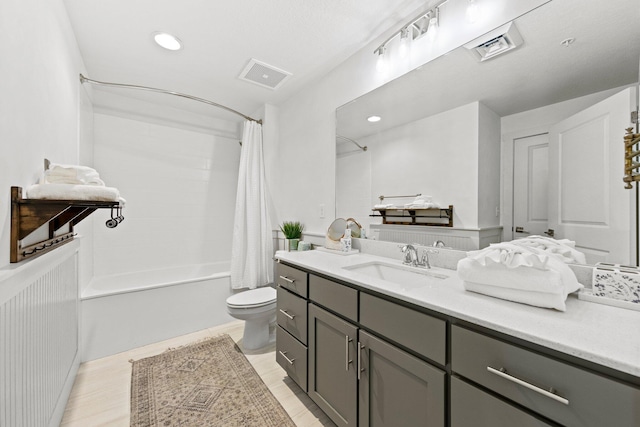 full bathroom featuring vanity with extensive cabinet space, toilet, and shower / tub combo with curtain