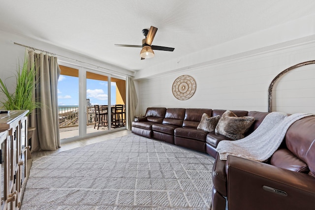 living room with ceiling fan and light wood-type flooring