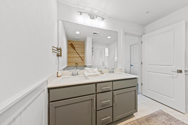 bathroom with tile floors and dual vanity