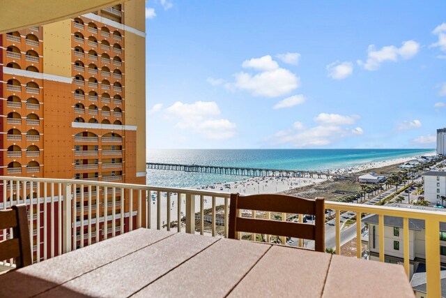 balcony with a beach view and a water view