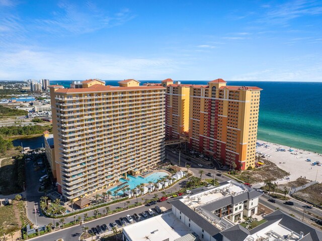 birds eye view of property featuring a beach view and a water view