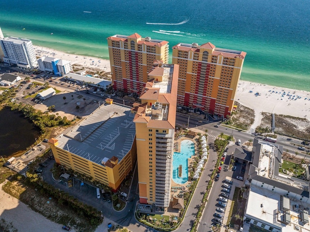 drone / aerial view featuring a beach view and a water view