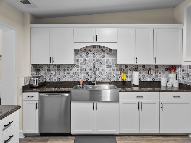 kitchen featuring backsplash, dishwasher, and white cabinetry