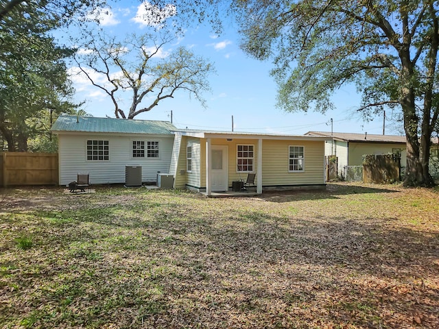 rear view of property featuring central AC unit