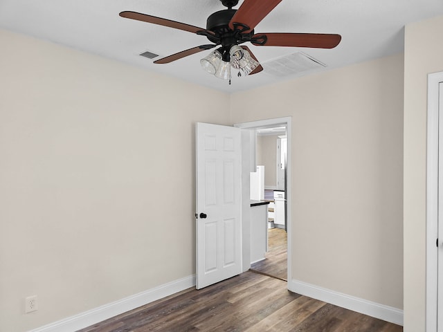 empty room featuring hardwood / wood-style flooring and ceiling fan